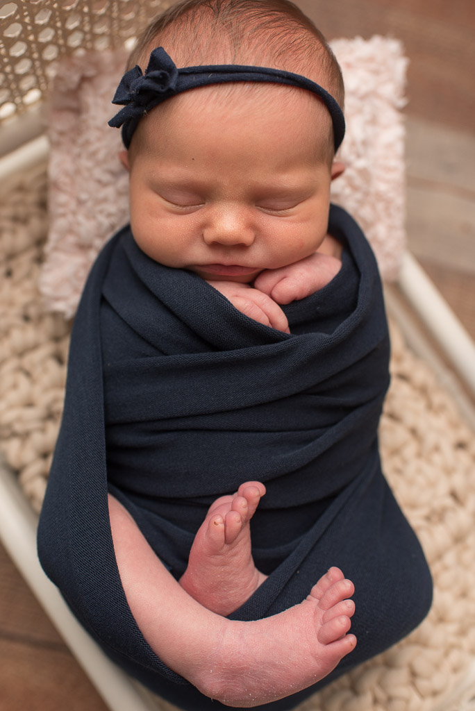 Baby girl wrapped in navy blue