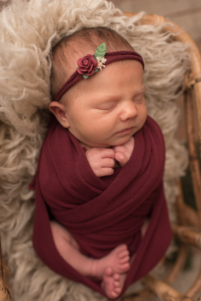 Newborn baby girl at studio newborn session in red | Sharon Leger Photography