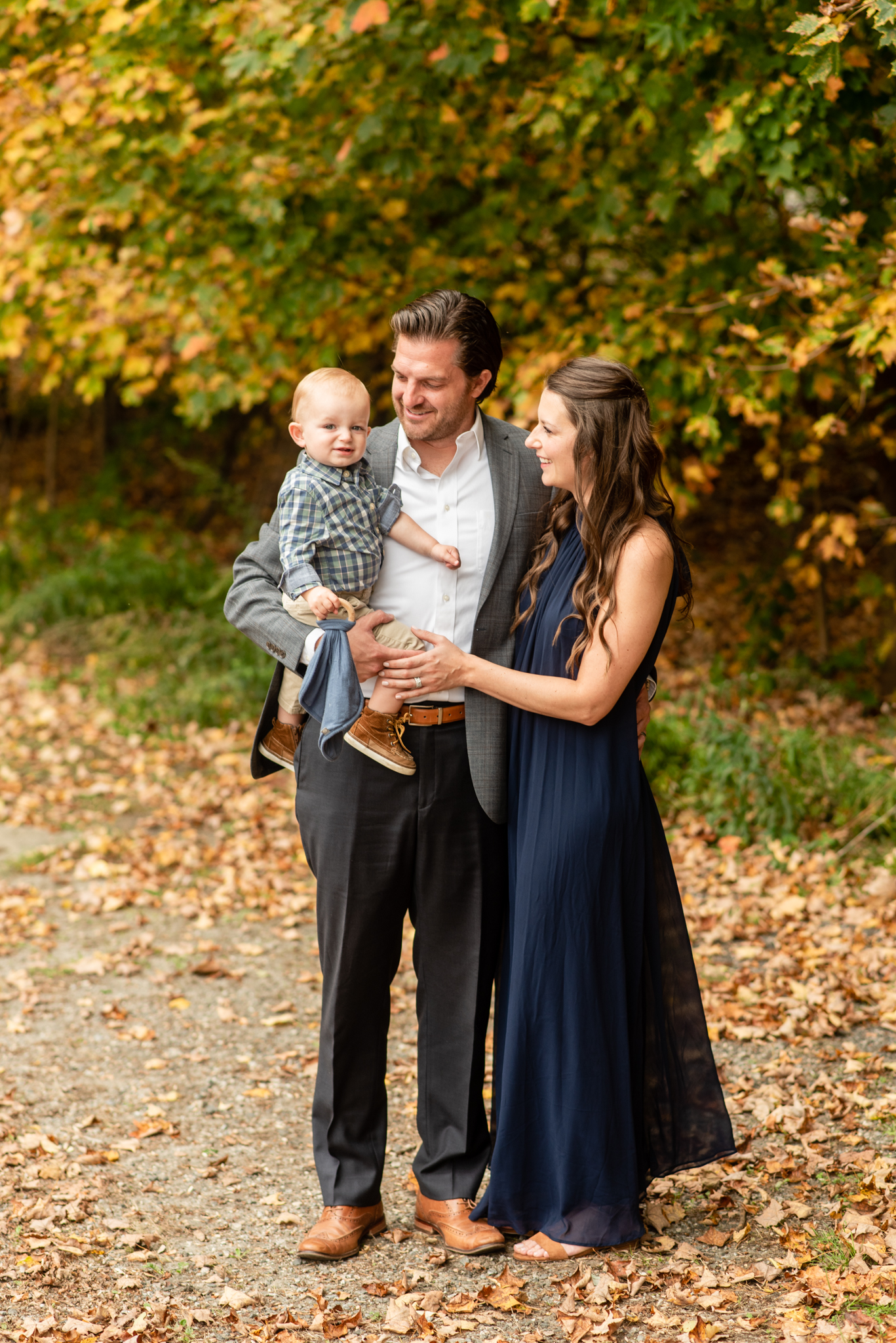 Family of three at fall foliage session in Burlington, Connecticut