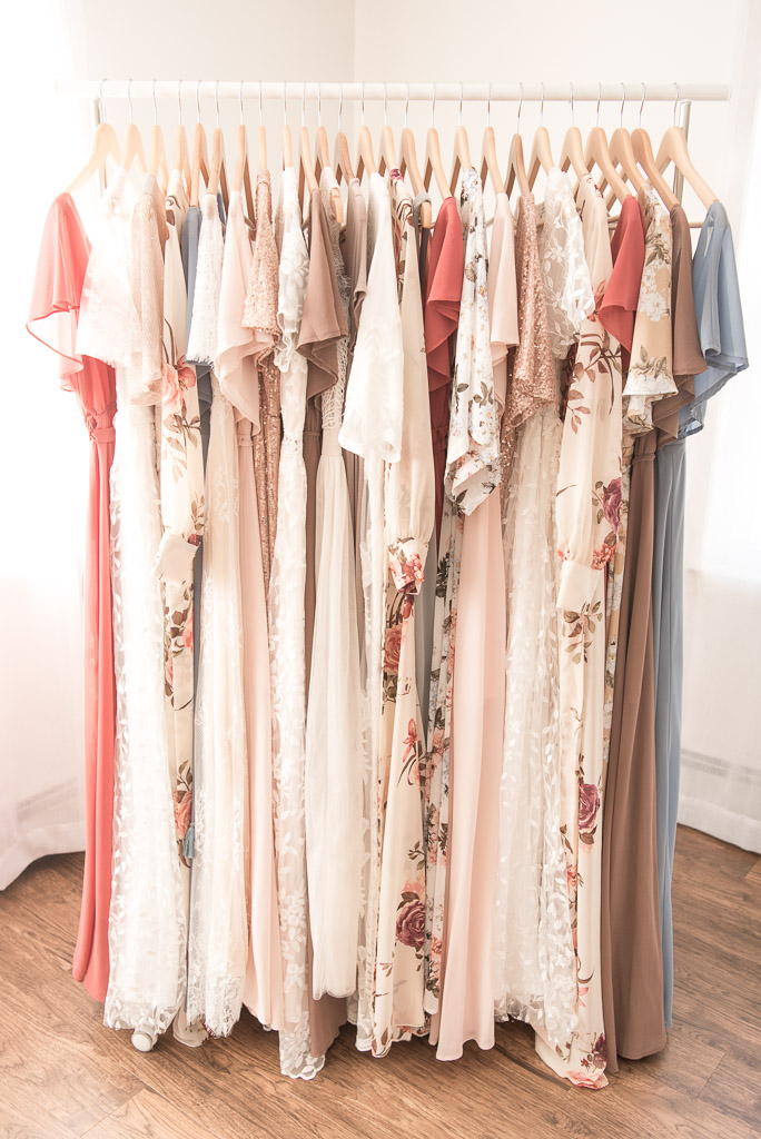 Close up of neutral colored dresses on hangers for Client Closet
