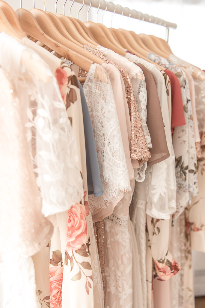 Close up of neutral colored dresses on hangers for Client Closet | Sharon Leger Photography, Connecticut Newborn and Family Photographer | Client Closet