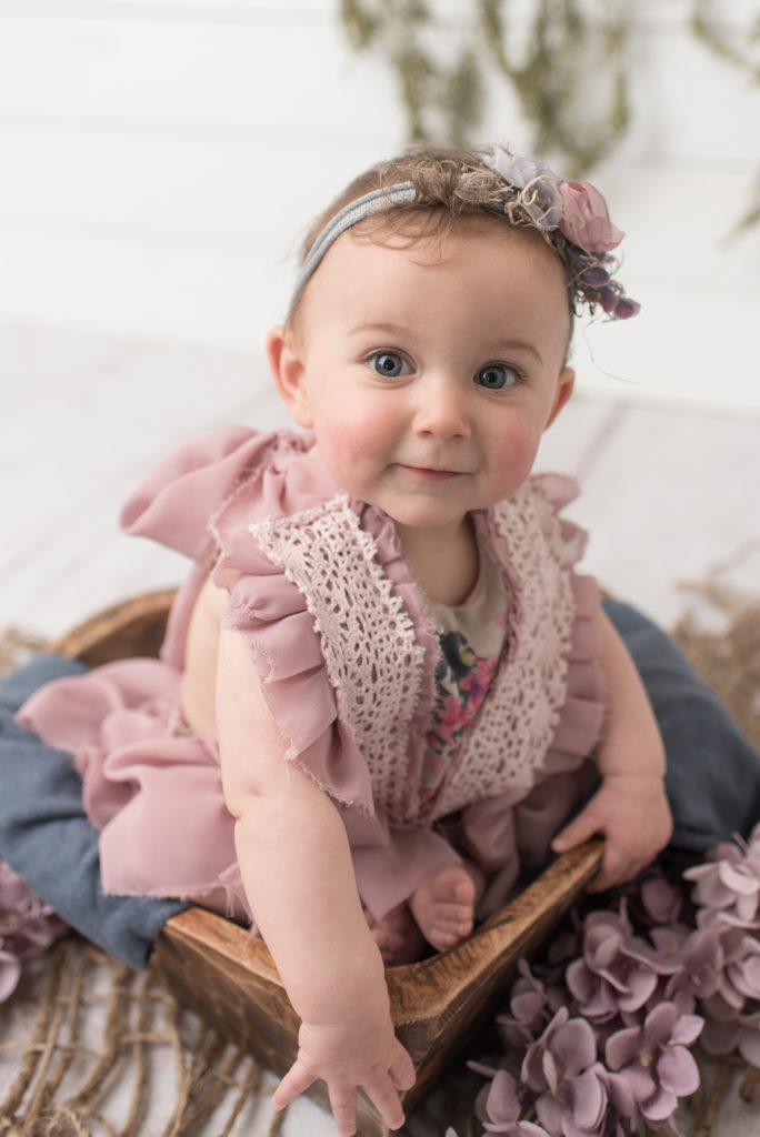 Six month old girl in purple dress