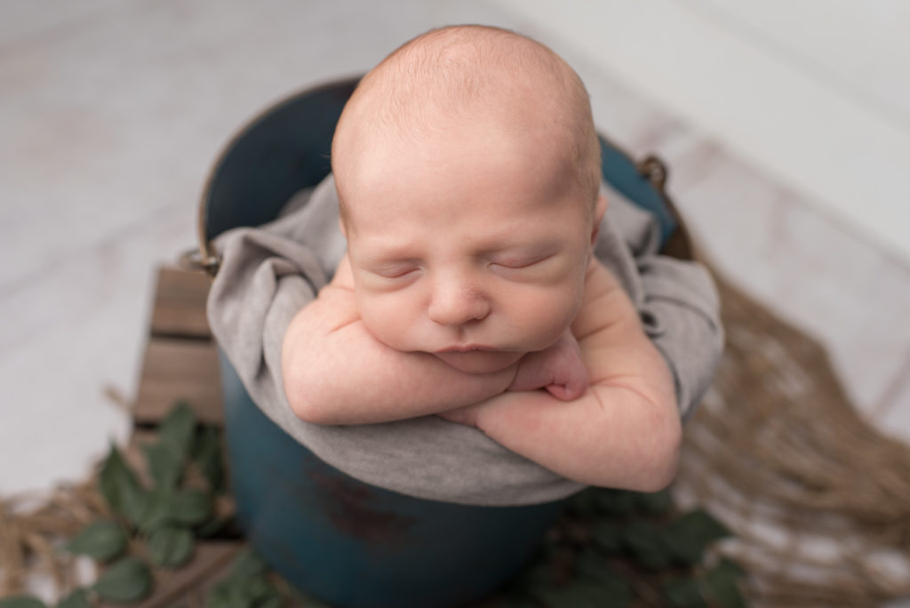 Baby boy in teal bucket