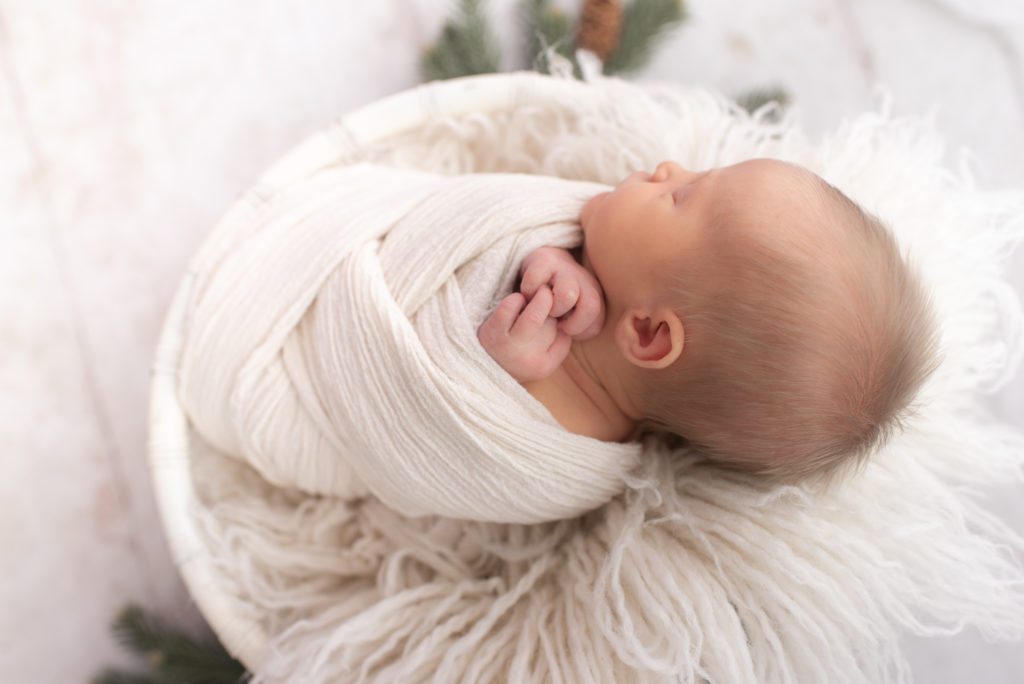Baby boy wrapped in white for newborn session in Canton, Connecticut