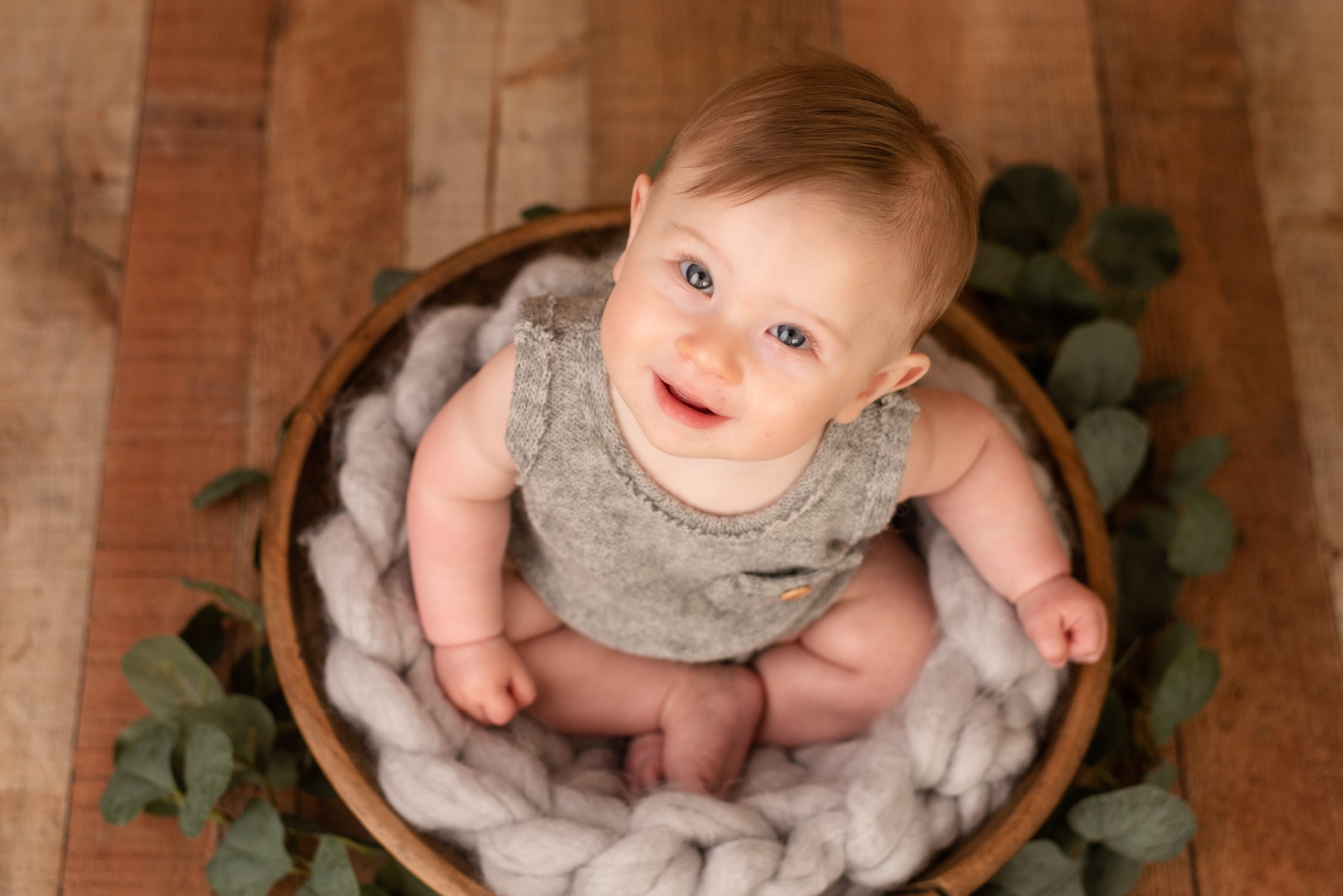 An overhead shot of a baby boy at his milestone session