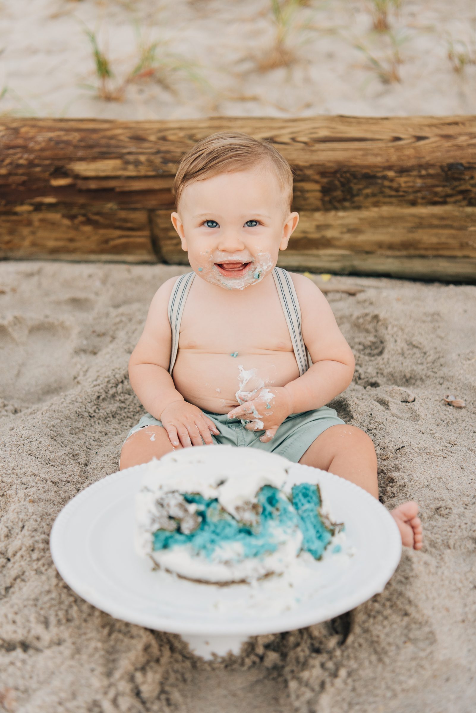 One year old at his first birthday beach cake smash
